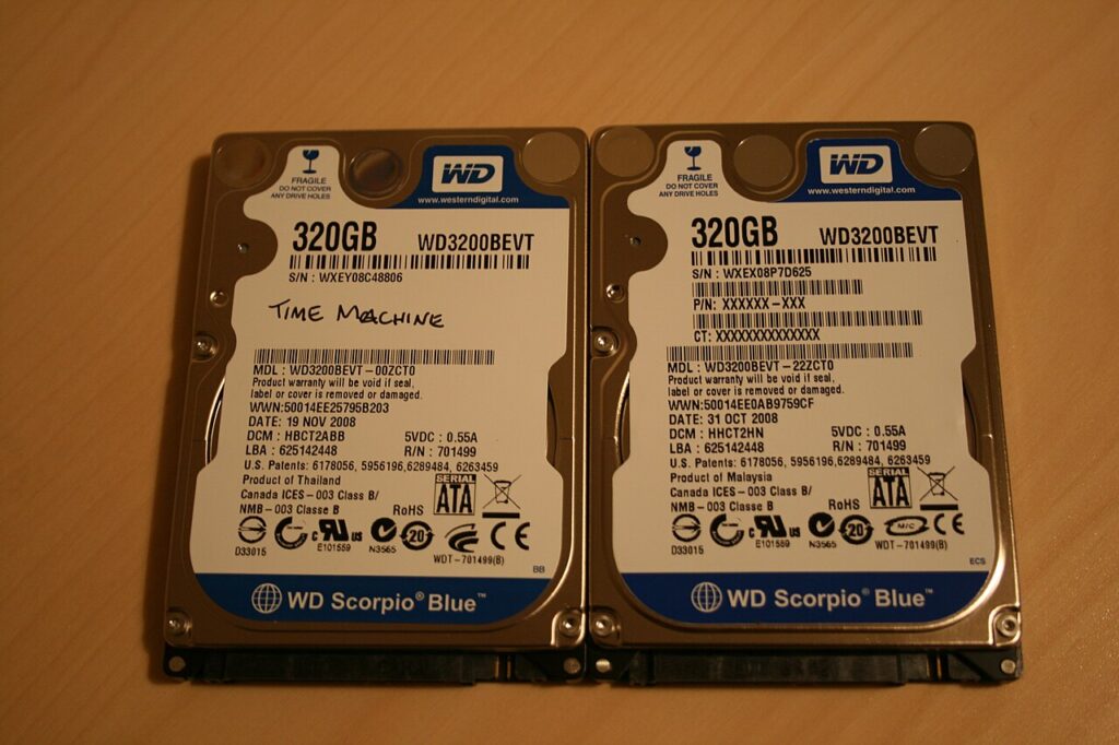 A laptop hard drive and storage drive on a desk