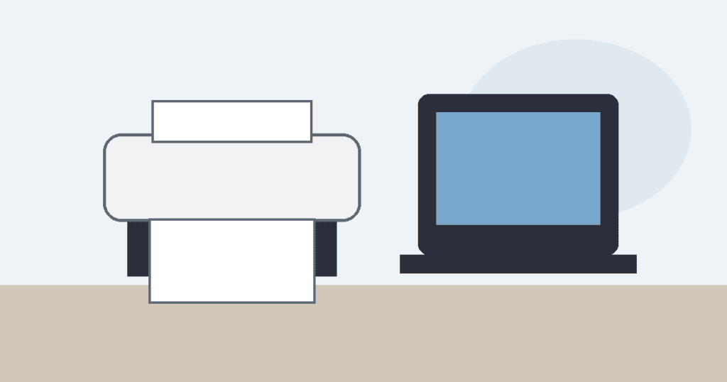 Home printer beside a laptop on a desk