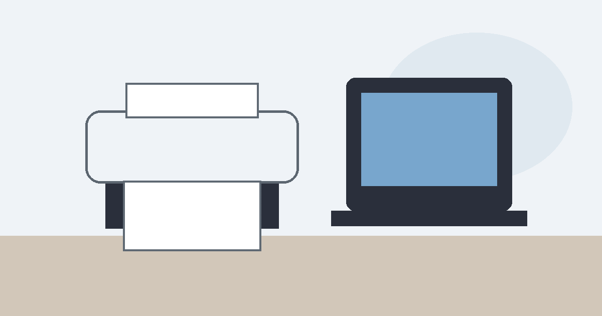 Home printer beside a laptop on a desk