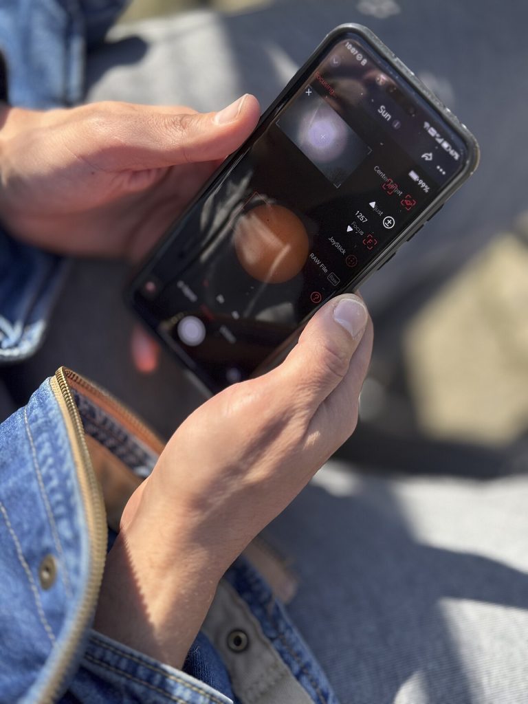 Phone held outdoors in bright sunlight