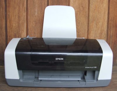 Inkjet printer on a desk for reducing printer ink costs