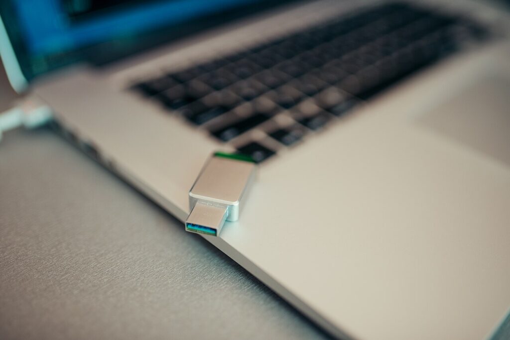 USB flash drive plugged into a laptop for safe file sharing