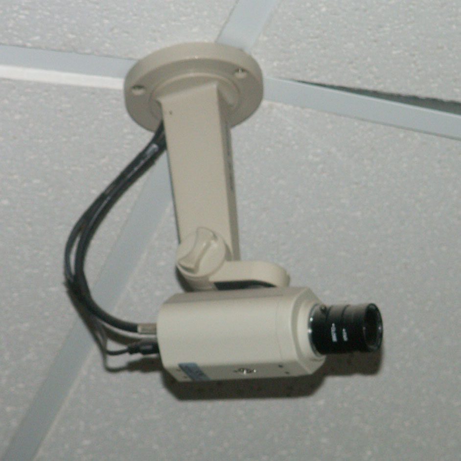 A small security camera mounted for indoor monitoring
